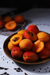 Fresh ripe apricots in bowl in rustic style