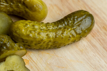 Pickled cucumbers on a wooden table during cooking