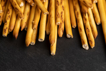 Thin and long bread sticks made of wheat flour on the table
