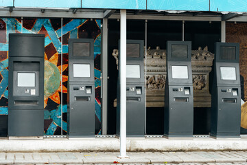 Several self service payment terminals in the street