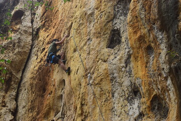 Rock climbing at Goa Pawon cliff in Bandung, West Java, Indonesia
