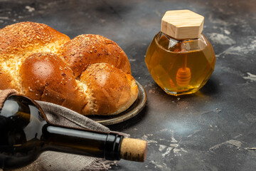 Shabbat Shalom challah bread, shabbat wine on a dark background, place for text, top view