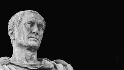 Julius Caesar, the most famous general and leader of Ancient Rome. An old bronze statue replica along Imperial Fora Rome in Rome (Black and White with copy space)
