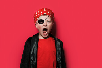 Cute boy in pirate costume screaming to the camera