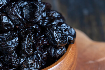 Ripe plums of dark color on the table