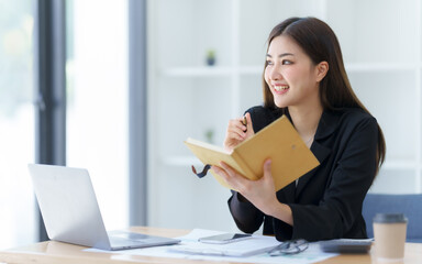 Attractive asia busy business woman consultant auditor working at modern office with balance sheet accounting bookkeeping documents. Account verification to prevent fraud bribery.