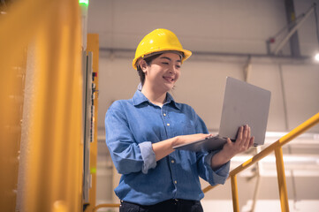 Asian woman are engineer factory inspecting machine in factory  with computer, Asian woman engineer working in factory concept