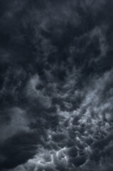 Obraz premium dark clouds make sky in black. Heavy rain thunderstorm. Pattern of clouds overcast predict tornado, Hurricane or thunderstorm and rainy. Dark sky cloudy have storm and lightning thunderbolt.