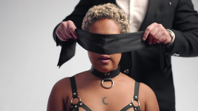 Diverse couple in a intimal moment where man blindfolds woman. Realtime