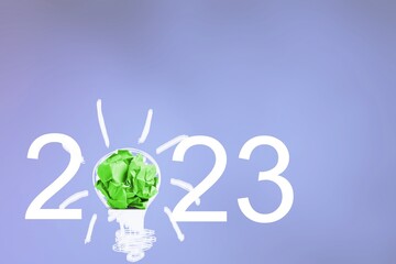2023 numbers and Green paper in shape of light bulb