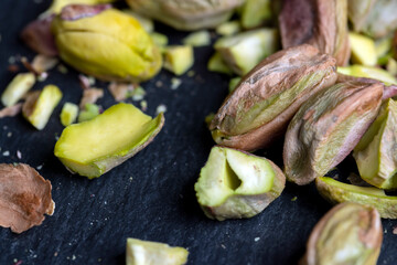 Scattered pistachios of green color with salty taste