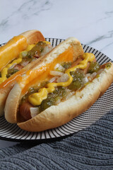 Hot dogs with all the fixings on toasted cheese buns.