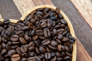 Beans in heart-shaped tra,y representing love of coffee