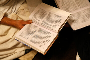 Gita Jayanti celebration in an ISKCON temple. Devotees reading the Bhagavad Gita. Sarcelles. France.