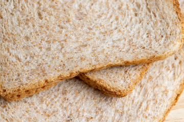 Square loaf of light wheat bread cut into pieces