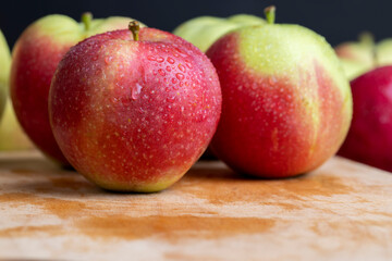 Fresh red and green apples on the kitchen table