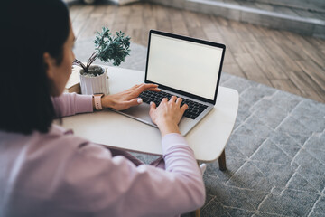 Anonymous woman typing on laptop keyboard