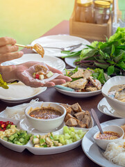Enjoy eat with Vietnamese Meatball Wraps (Nam-Neung), Pork Sausage wraps with fresh vegetables in rice paper, generous platter eat with sweet sauce. Vietnamese Pork Sausage and salad. Selective focus.