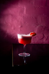 Pink Cocktail red on a Pink background in the bar