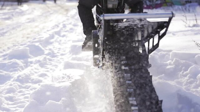 Snow motorcycle rides on snowdrifts. Snowbike skidding in the snow slow motion. Winter transport concept.