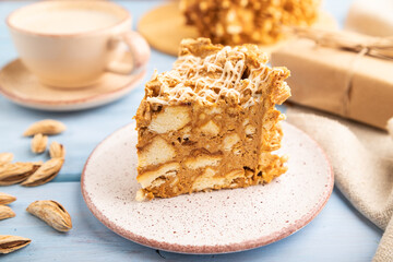 Traditional lithuanian cake shakotis with cup of coffee on blue, side view, selective focus.