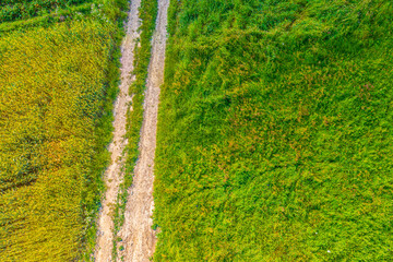 Aerial view of agriculture fields and road . Arable land view from above