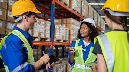 Group of diversity worker meeting and talking in warehouse checking inventory in industry factory.