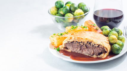 Beef Wellington, served with brussels sprouts and Chateau potato, copy space