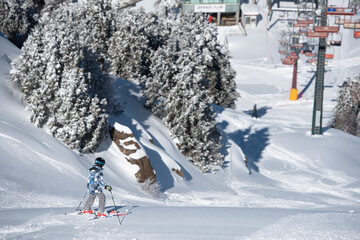 Unrecognized young person doing skiing at snow. Winter athletic sports. Troodos mountains Cyprus