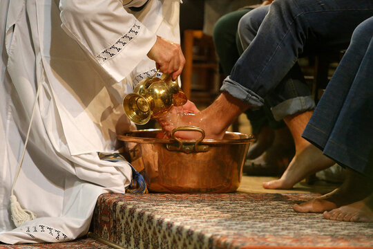 Maundy Thursday celebration in a Parisian catholic church. Priest washing faithfuls' feet. - Powered by Adobe