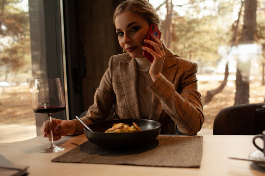 Young Woman Drink Wine In Restourant And Talking On The Phone