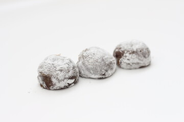 a close up of chocolate flavored mochi isolated on white background.