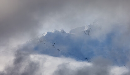 Tantalus Range covered in Snow and Clouds during Winter Season. Near Whistler and Squamish, British Columbia, Canada. Nature Background