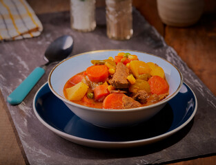 Chunky beef casserole in a rustic setting.
