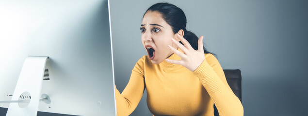 angry woman with computer in office