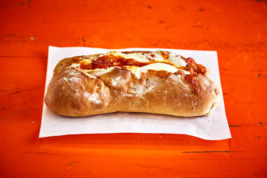 Hot dog with cheese and chilli sauce takeaway
