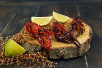 boiled craw fish on kitchen board with net and lemon slices closeup photo © ulianna19970