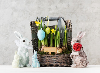 Happy easter festive card with Easter eggs, Bunnies and beautiful spring flowers in the basket. easter concept