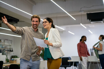 Obraz premium Group of happy multiethnic business people having fun and chatting at workplace office