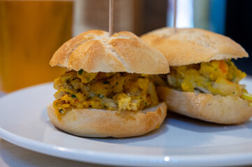 Typical mini burger snack of Basque Country, pinchos or pinxtos, small piece of bread with different toppings, served in bar in San-Sebastian or Bilbao, Spain