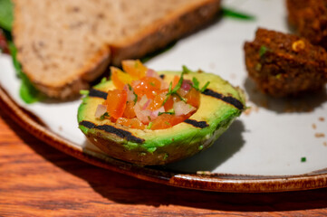 Healthy vegetarian food, vegan falafel balls served with grilles baked eggplant and grilled avocado