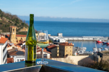 Tasting of txakoli or chacolí slightly sparkling very dry white wine produced in Spanish Basque...