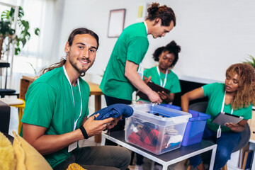Volunteers putting clothes in donation boxes, social worker making notes charity