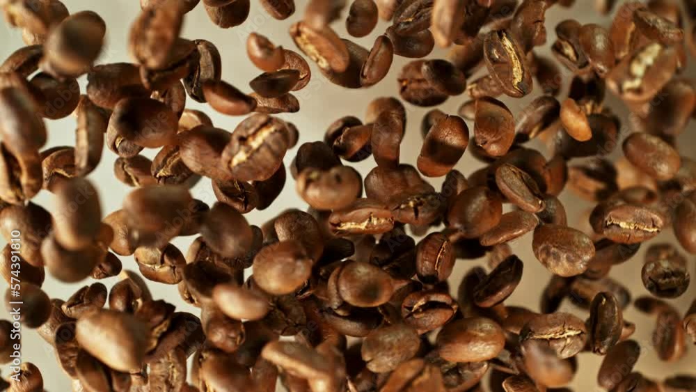Poster super slow motion of rotating coffee beans on black background. filmed on high speed cinema camera, 