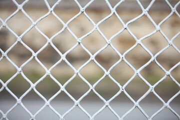 Fototapeta premium White metal wire in cubes as a net or fence