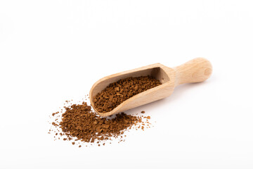 Soluble coffee grains in a wooden spoon isolated on a white background.