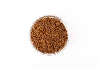 Instant coffee grains in a glass bowl isolated on white background.