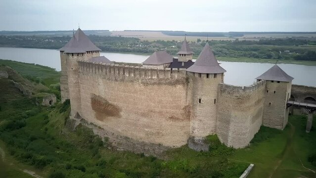 Panorama aerial view of old castle Hotin near river. Khotyn Fortress - medieval castle on yellow autumn hills. Ukraine, Eastern Europe. Architecture of Middle Ages in our time, View of the castle 