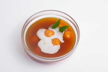 Kolak, Indonesian compote made from sweet potatoes served with coconut milk in dark background