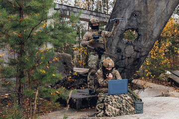 Concept smart war robots. Soldier engineer use laptop for transmits aerial photo and data from...